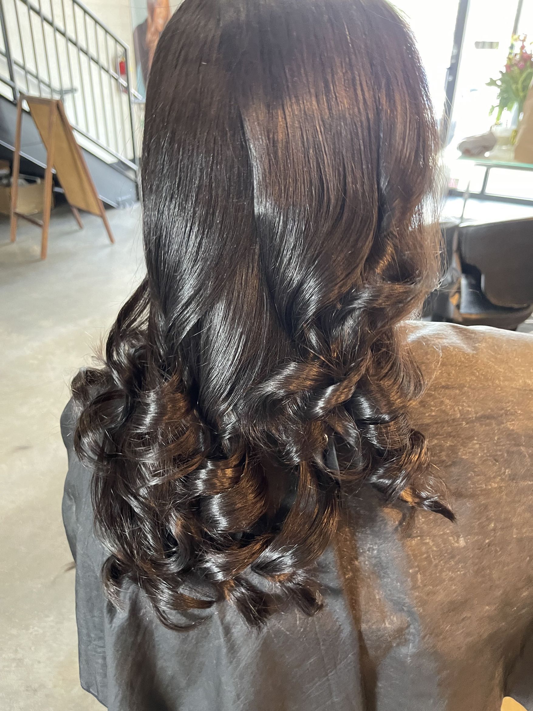 Glossy dark curls blowout